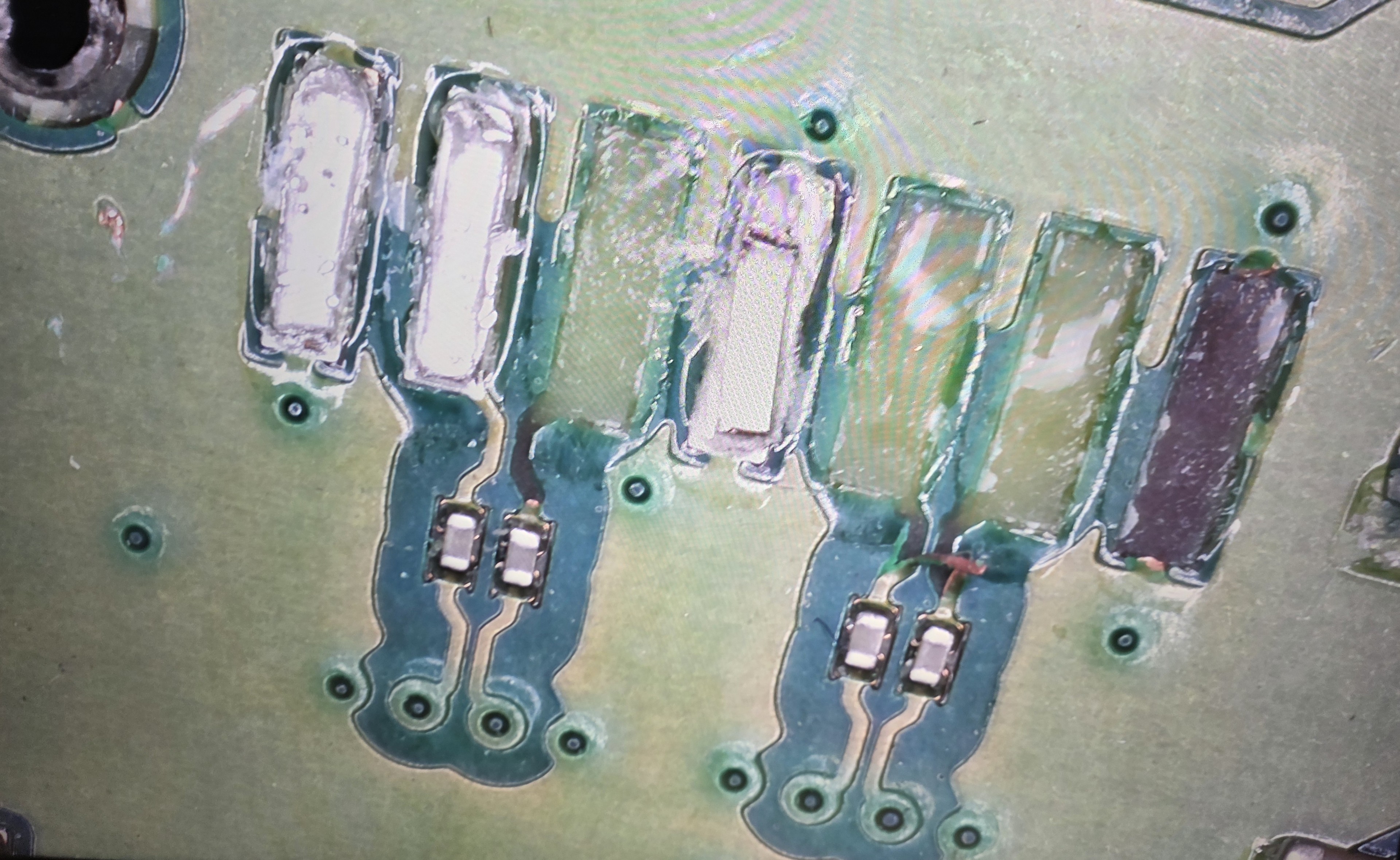 Damaged laptop connector pads under microscope